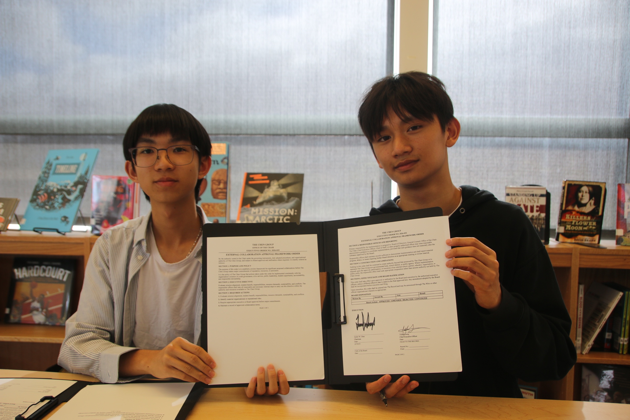 Justin Chen and Aiden Leung presenting a signed executive order